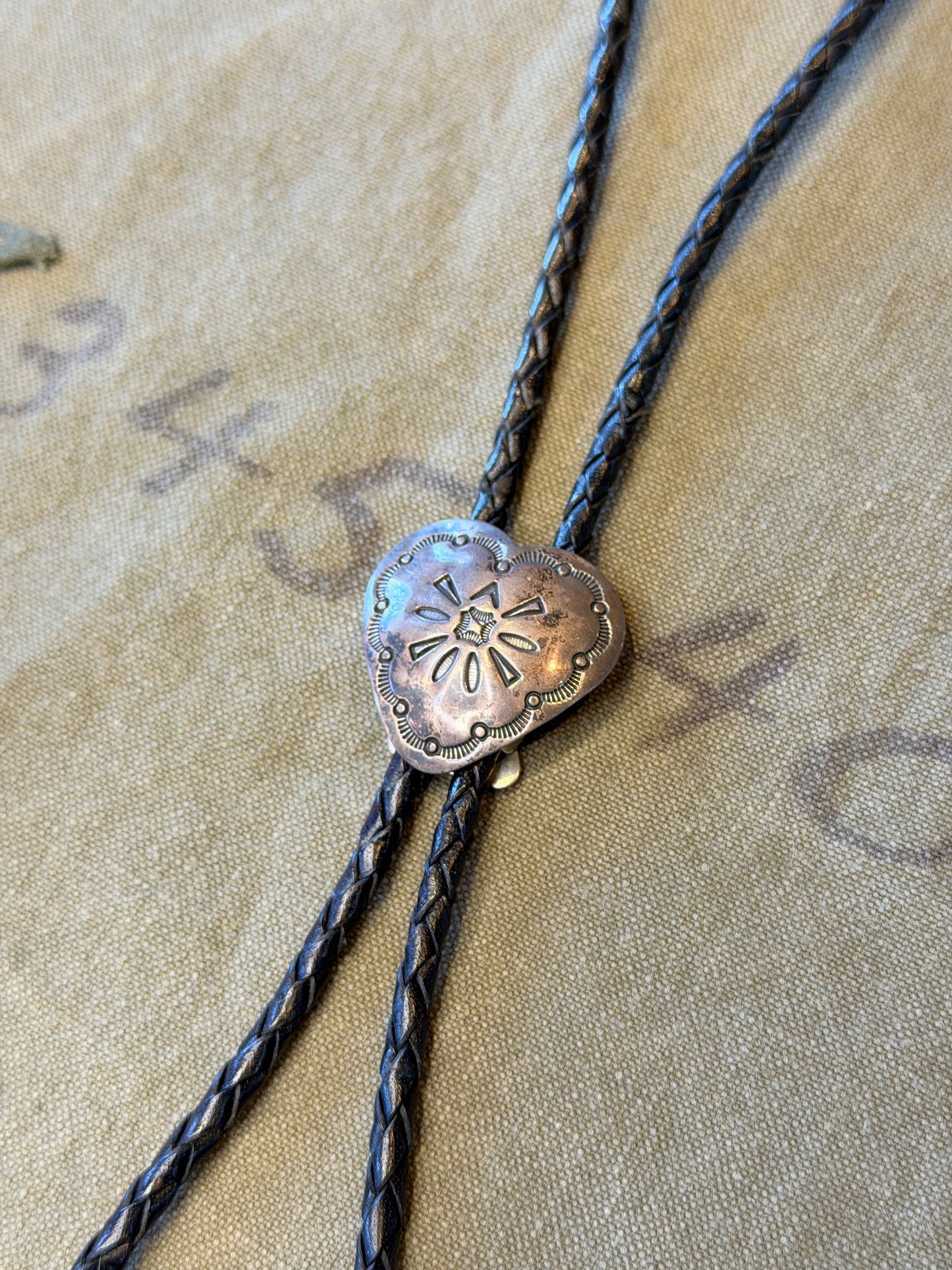 Stamped Silver Heart Bolo Tie — Floral Repoussé, Black Cord