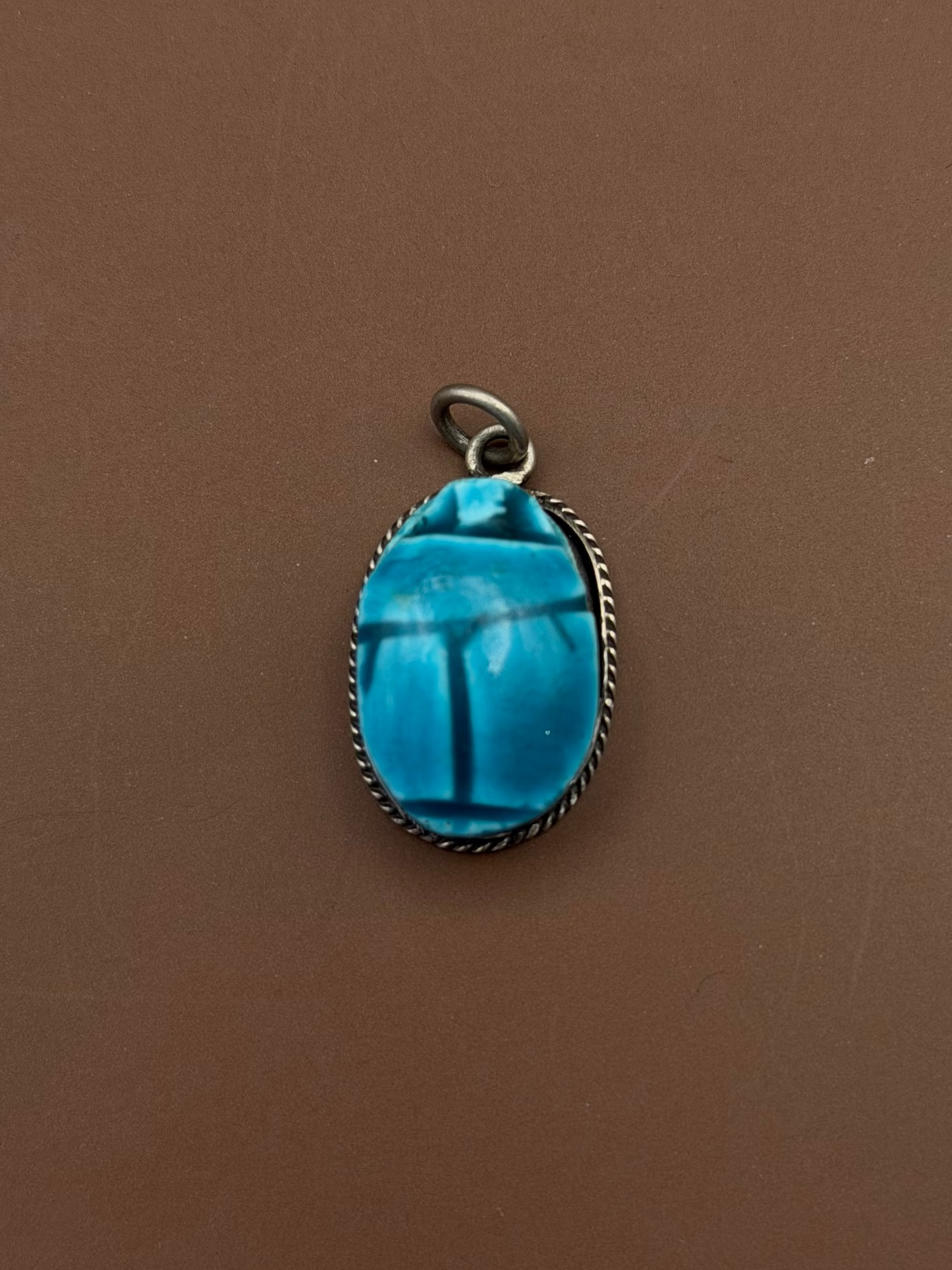 Silver framed pendant with Hand carved soap stone with blue glaze.
