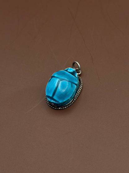 Silver framed pendant with Hand carved soap stone with blue glaze.
