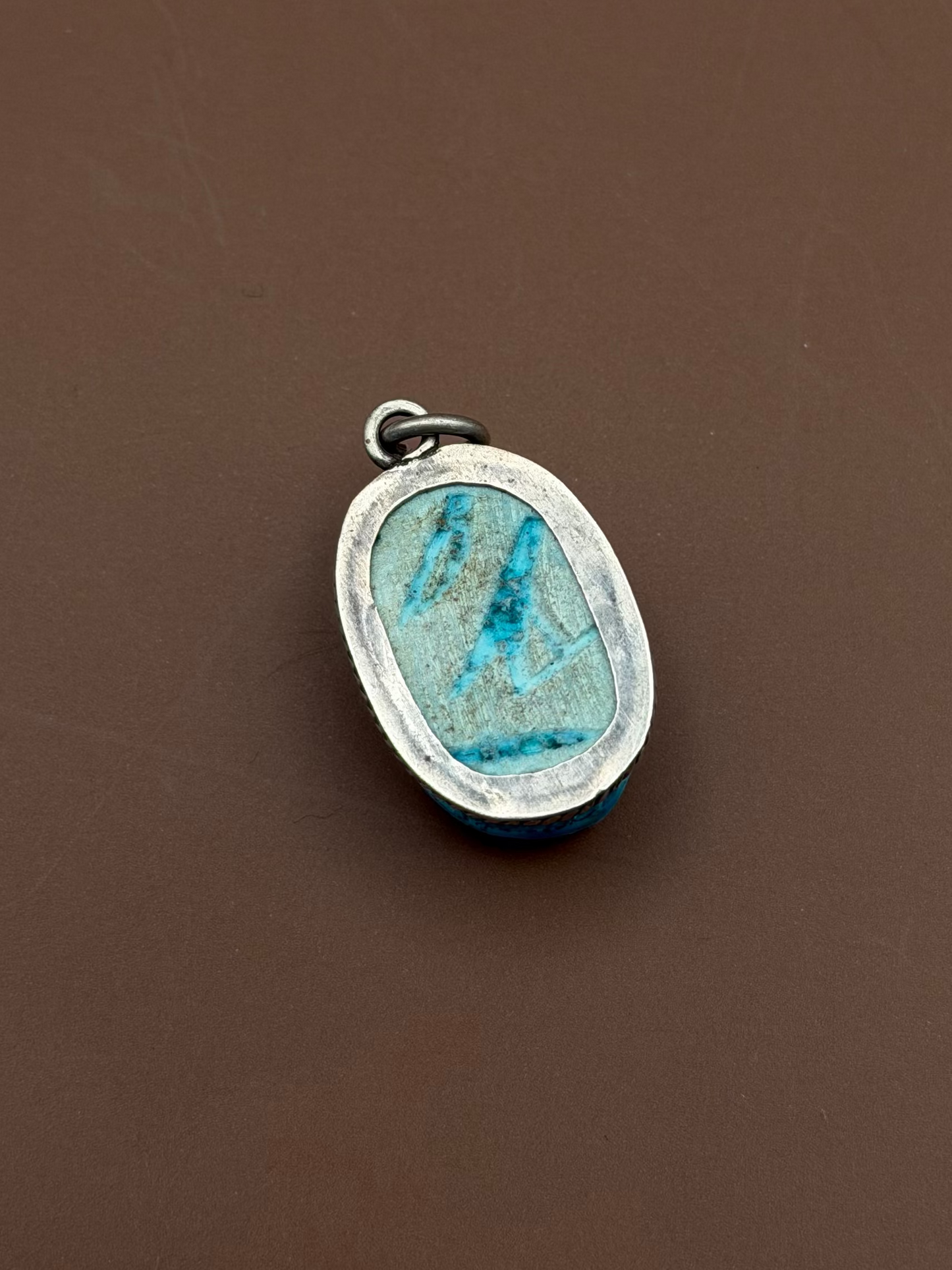 Silver framed pendant with Hand carved soap stone with blue glaze.