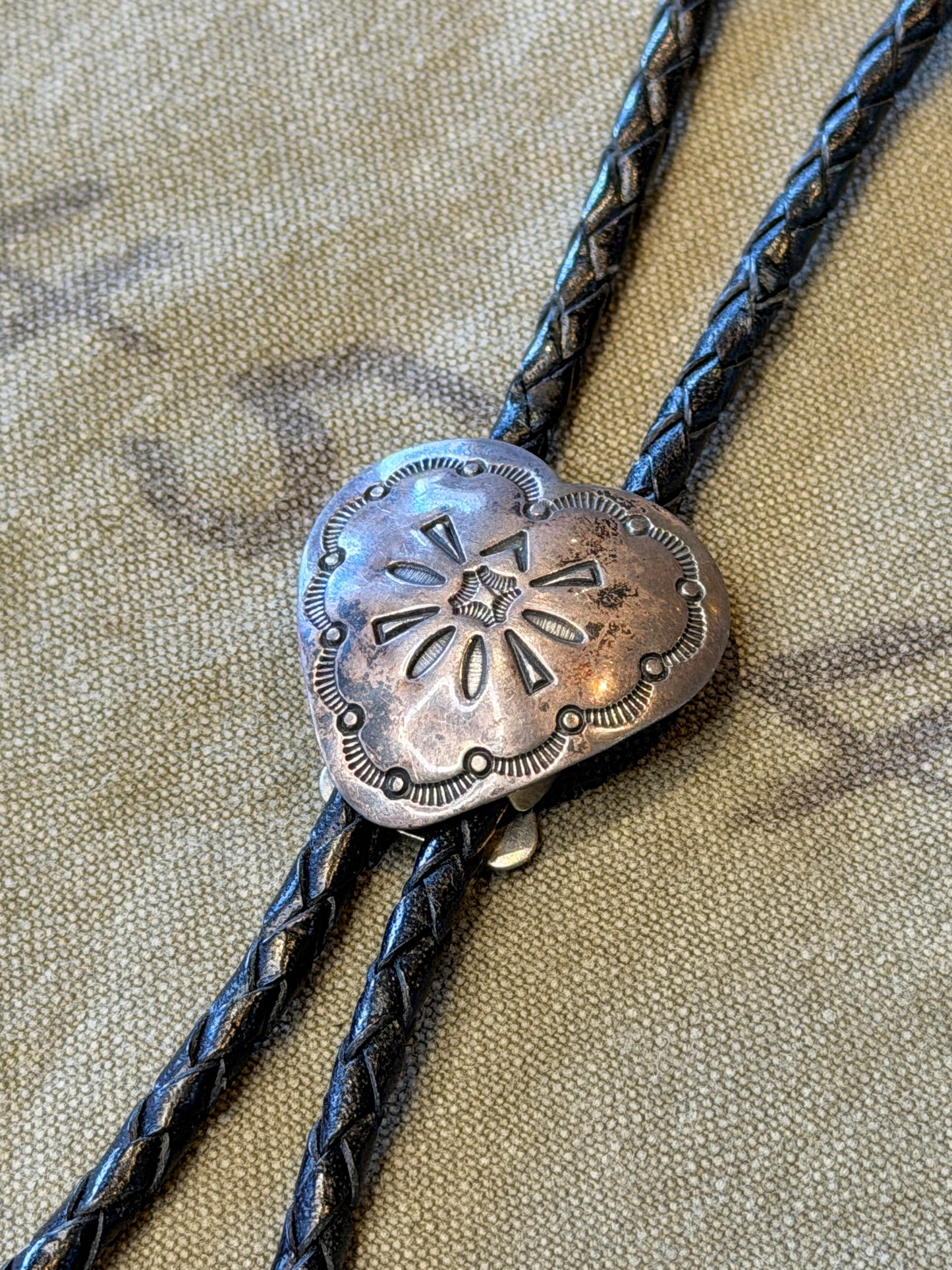 Stamped Silver Heart Bolo Tie — Floral Repoussé, Black Cord